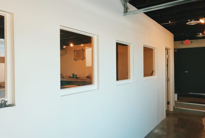 Salvaged interior windows bringing more natural light into the interior spaces at Two Bettys Refill Station