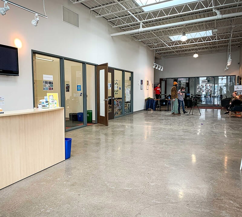 A large, open commercial space with polished concrete floors