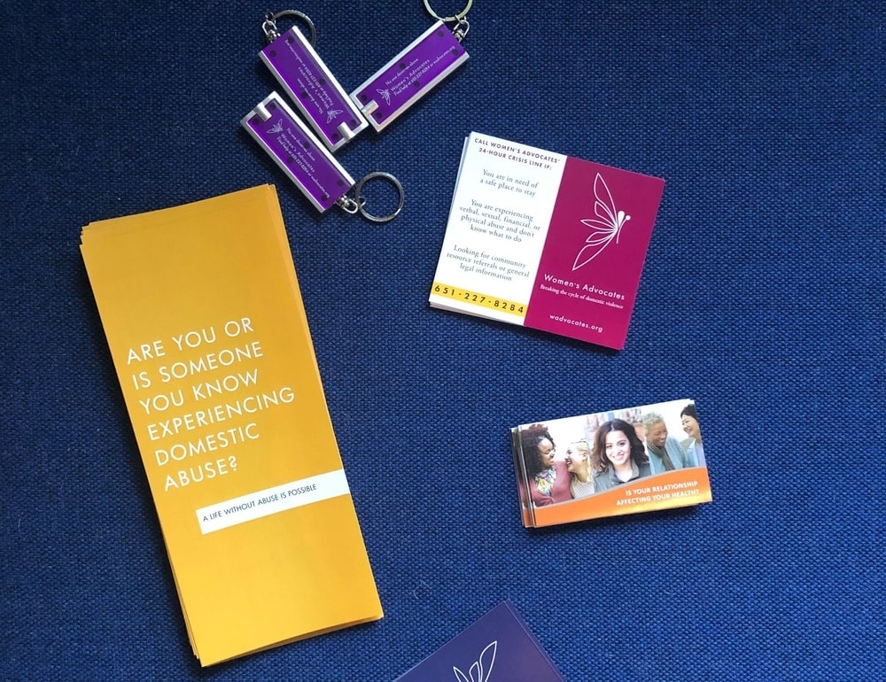 Brochures, info cards, and keychain lighters from Women's Advocates